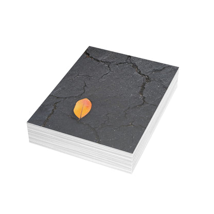 Orange Leaf on Black Concrete Inspirational Postcard – Minimalist Autumn Decor for Modern Homes