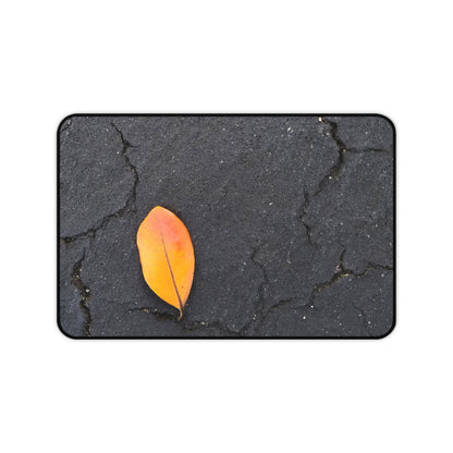 Orange Leaf Against Black Concrete Desk Mat – Minimalist Modern Nature-Inspired Tabletop Decor