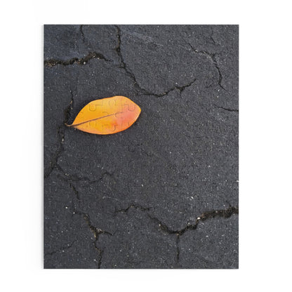 Orange Leaf on Black Concrete Puzzle – Moody Autumn Jigsaw for Minimalist Fall Decor and Nature Lovers